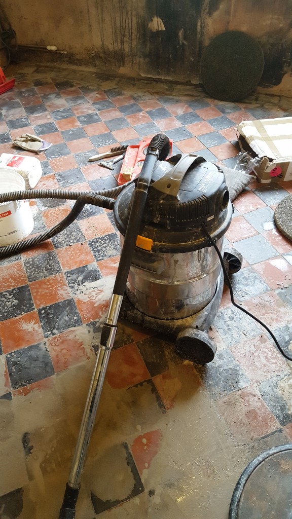 Red and Black Quarry Tiled Kitchen Floor Covered in Screed During Cleaning in Mobberly