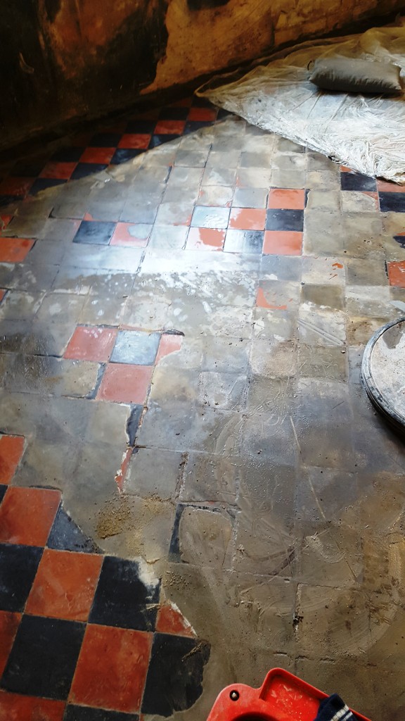 Red and Black Quarry Tiled Kitchen Floor Covered in Screed During Cleaning in Mobberly