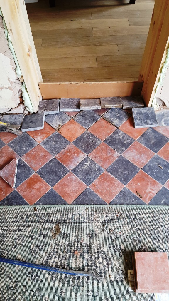 Red and Black Quarry Tiled Kitchen Floor Showing Damaged Tile Section in Mobberly