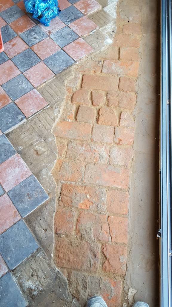 Red and Black Quarry Tiled Kitchen Floor Showing Damaged Tile Section in Mobberly